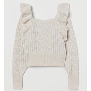 Flounced cable knit sweater